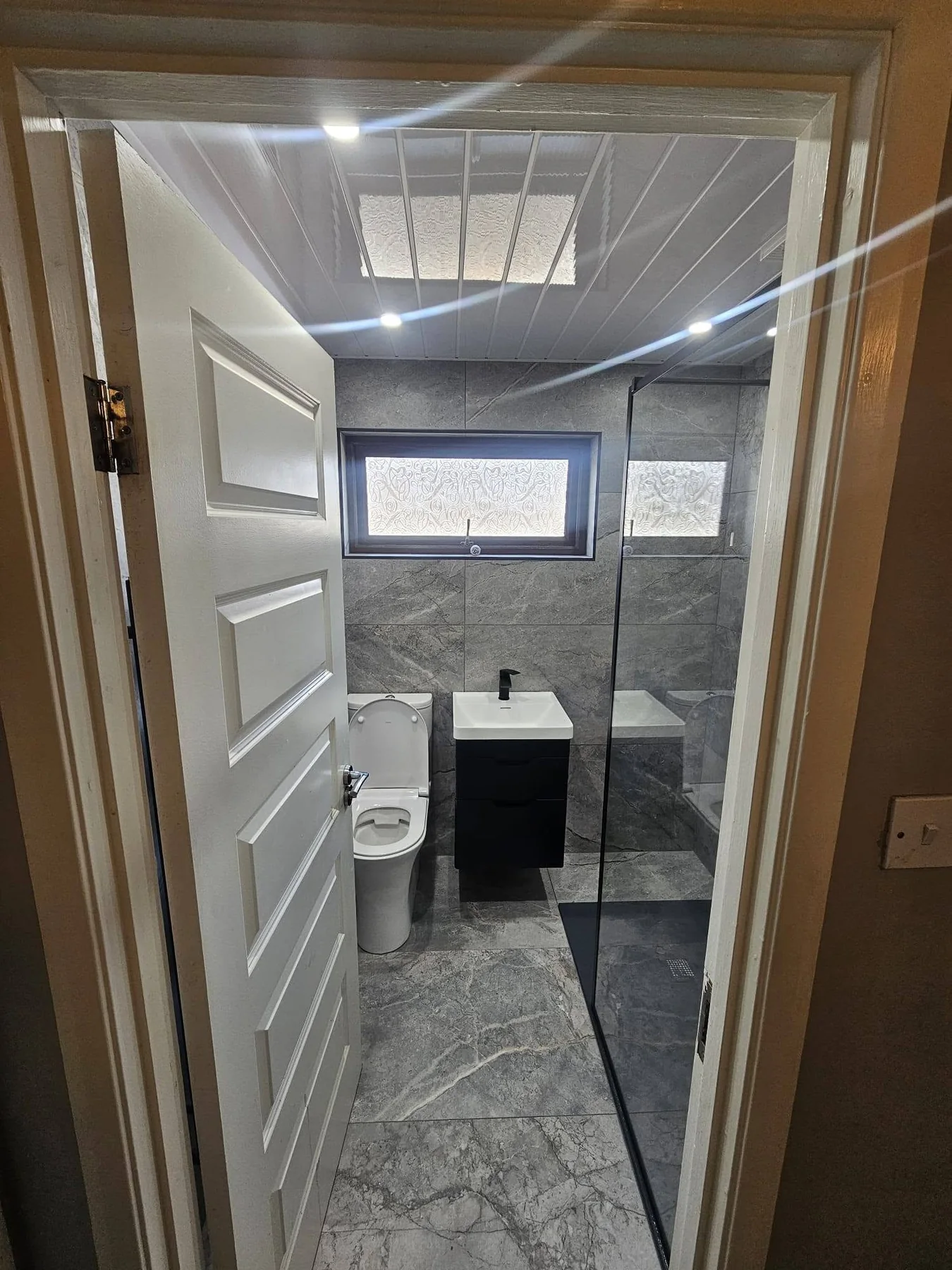 Completed bathroom photograph 5 of Monochrome Stone-Effect Shower Room